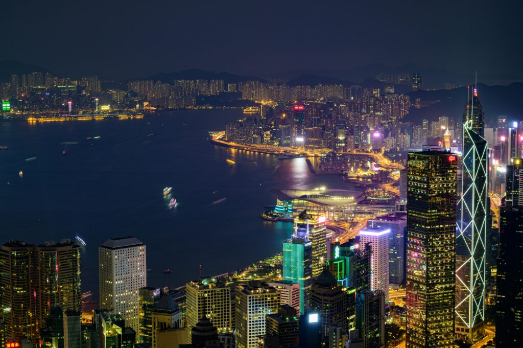 pexels-photo-3038813-3038813 Stunning nighttime view of Hong Kong Island with illuminated skyscrapers and vibrant cityscape across Victoria Harbor.