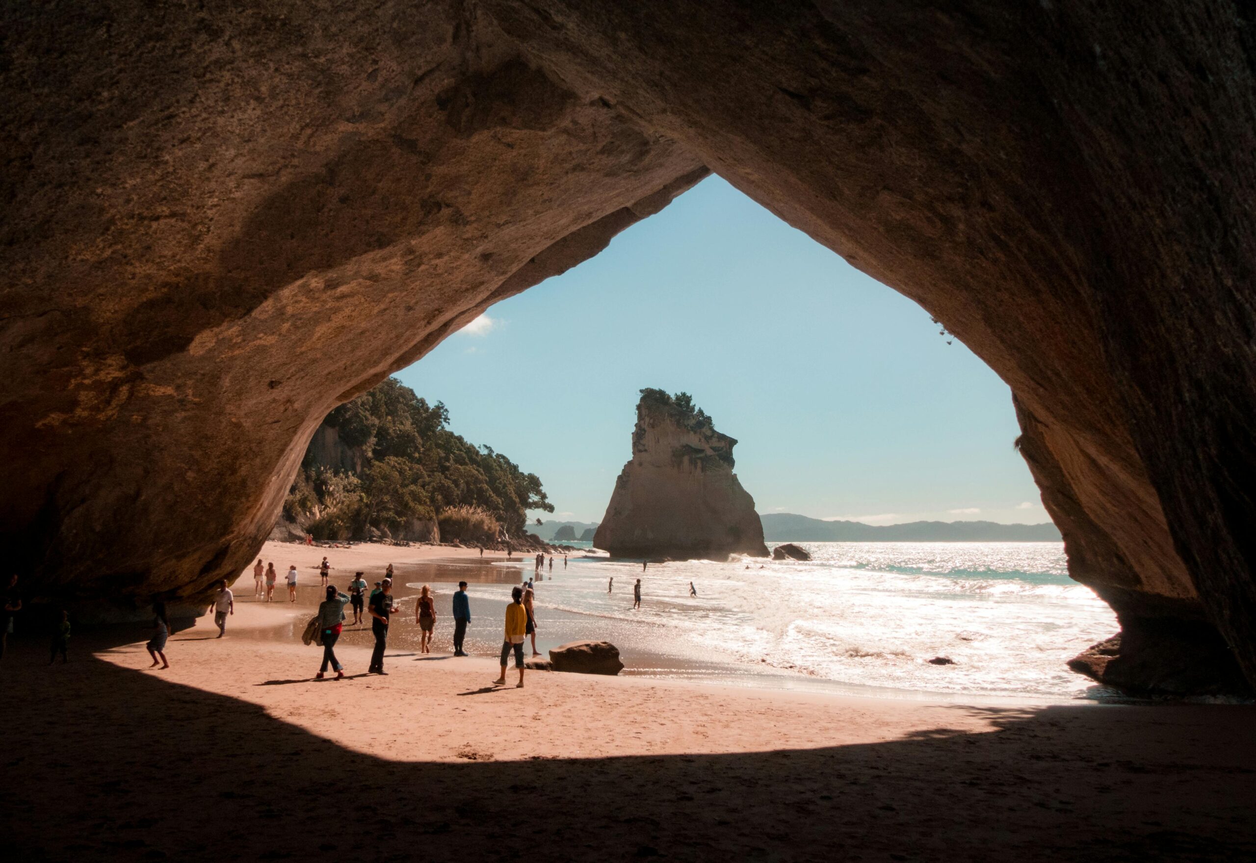 Explore the scenic Cathedral Cove in Hahei, New Zealand with a breathtaking beach view framed by natural rock formations.