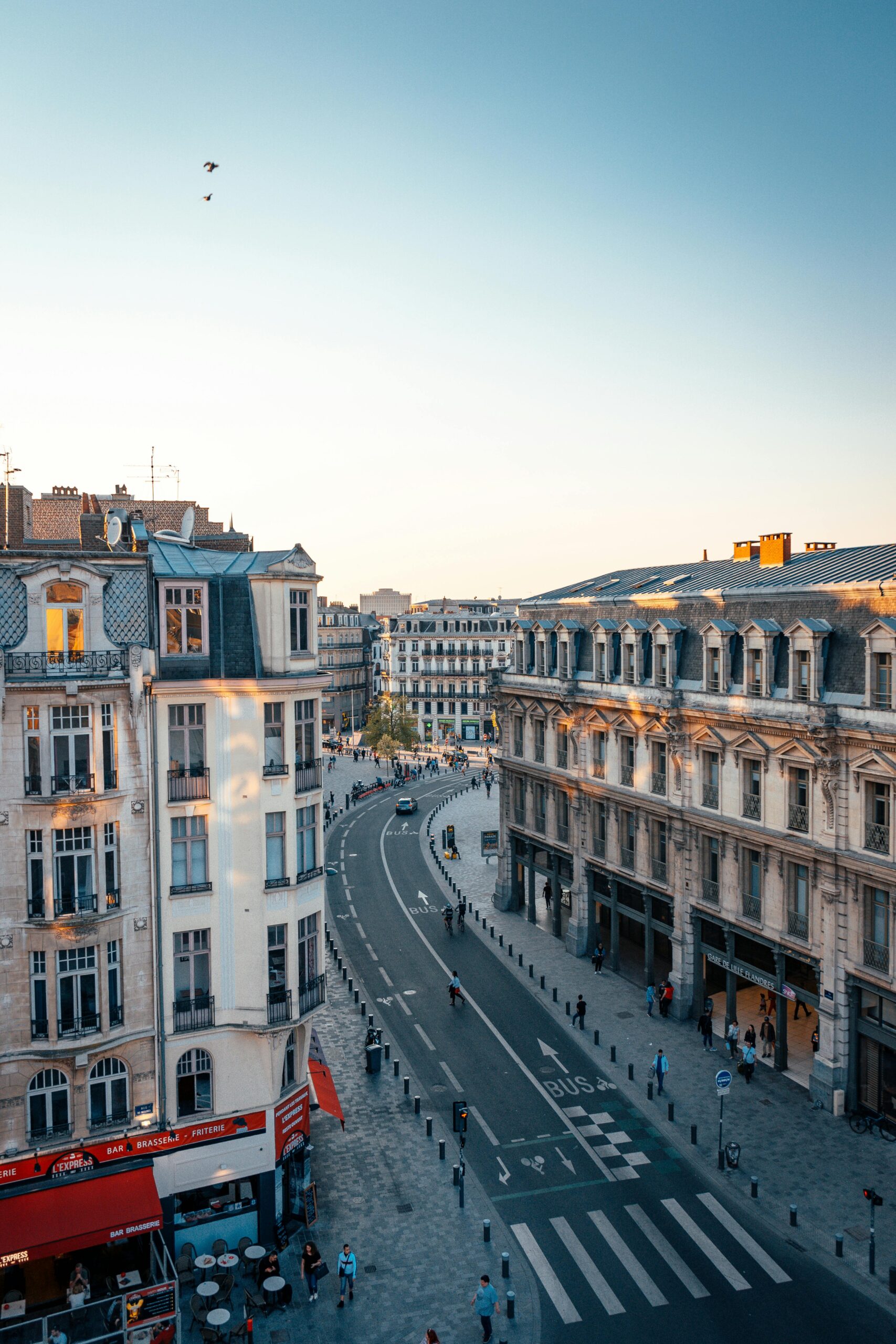 A beautiful aerial view of Lille's historic architecture and streets at sunset, showcasing urban charm.